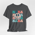 The Mama Print Crew Neck T-shirt is a dark gray unisex short sleeve top featuring retro MAMA in colorful bubble letters and a large smiley face with pastel hearts, crafted from soft Airlume cotton—perfect for spring and summer.