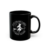 The Dust Em Off Ladies Halloween Mug is a black ceramic mug with white text featuring a witch on a broomstick and bats. It reads, Dust Em Off Ladies Its Ridin Season, perfect for those who love witchy vibes. Available in 11oz and 15oz sizes.