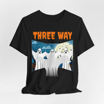 The Three-Way Mirror Ghost Tee features three wide-eyed cartoon ghosts against a spooky landscape and full moon, with THREE WAY in bold orange. Its a must-have unisex jersey tee inspired by the viral TikTok trend.