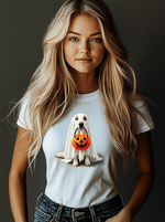 A long-haired blonde woman dons the Ghostly Pup Halloween T-Shirt - Adorable Trick or Treat Design, featuring a cartoon dog in ghost attire with a pumpkin bucket, set against a dark backdrop.