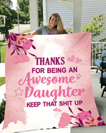 Pink floral-themed blanket with a bold, humorous message thanking an awesome daughter, held by a smiling woman outdoors.