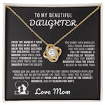 Gold love knot necklace with a sparkling crystal, presented in a gift box with a heartfelt message from a mother to her daughter