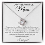 The To My Beautiful Mom Cubic Zirconia Love Knot Necklace features sparkling crystals on a 14k white gold over stainless steel pendant, presented in a box with a heartfelt “To my beautiful Mom” message on a white card background.