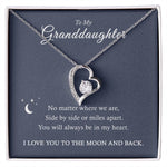 The To My Granddaughter - Forever Love Necklace features a heart-shaped pendant with a CZ crystal and comes in an elegant box. The message reads: No matter where we are, side by side or miles apart, you will always be in my heart. I love you to the moon and back.