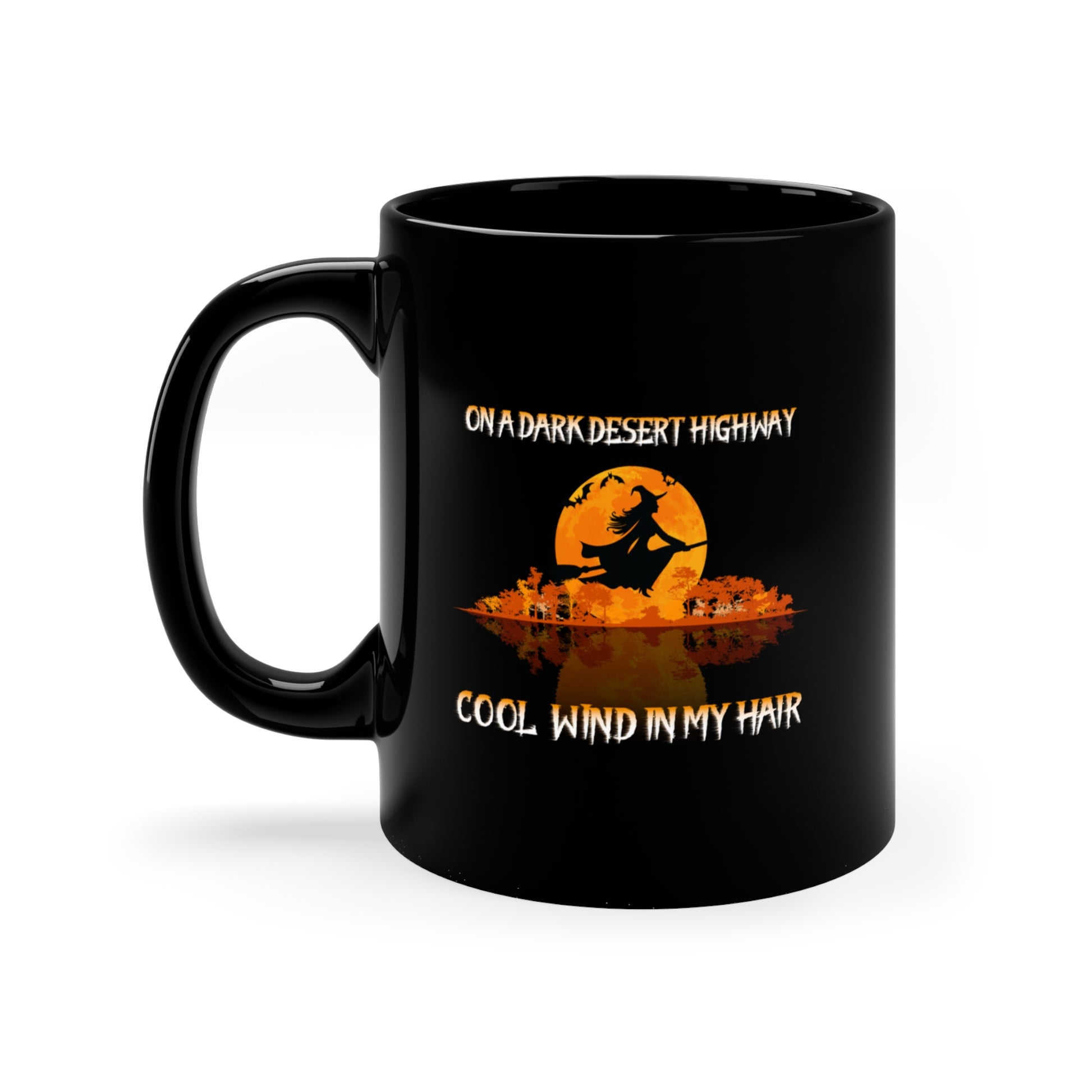 Add a magical touch to your morning brew with our 11oz On a Dark Desert Highway Halloween Witch Mug. This black ceramic mug features two witches flying over a silhouetted landscape and an orange moon, perfect for coffee lovers who appreciate the spooky charm.