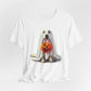 The Ghostly Pup Halloween T-Shirt, a unisex jersey short sleeve tee, showcases a ghost dog under a white sheet with a pumpkin bucket. This adorable trick-or-treat design adds spooky charm to any wardrobe with its plain background.