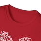 a red t-shirt featuring a heart-shaped word art design with kindness-related words in white text.