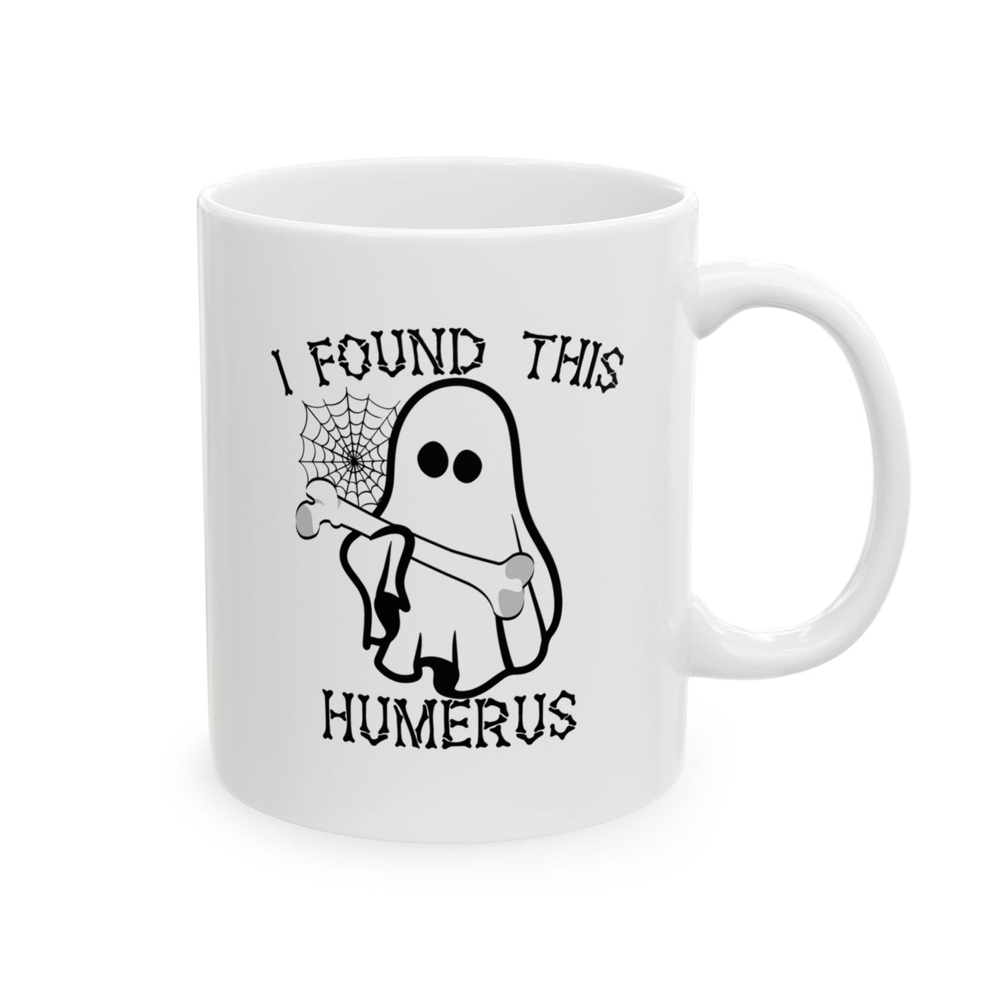 The I Found This Humerus Halloween Ghost Mug features a cartoon ghost holding a bone, complemented by a spiderweb and clever wordplay on humerus and humorous, making it an ideal coffee mug for spooky season enthusiasts.