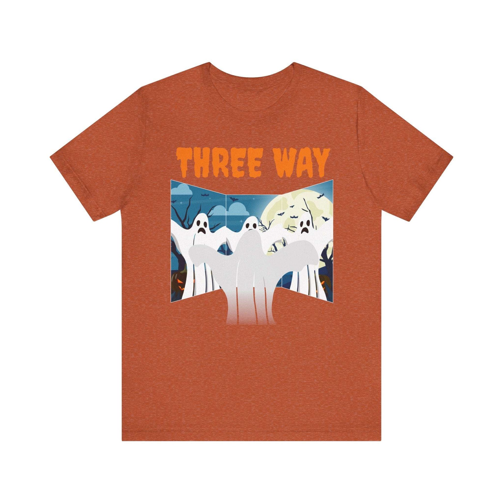 The Three-Way Mirror Ghost Tee is a vibrant orange, unisex jersey showcasing three cartoon ghosts and THREE WAY in bold font, set against a nighttime scene with a full moon, bats, and trees. Ideal for fans of the TikTok ghost style trend.