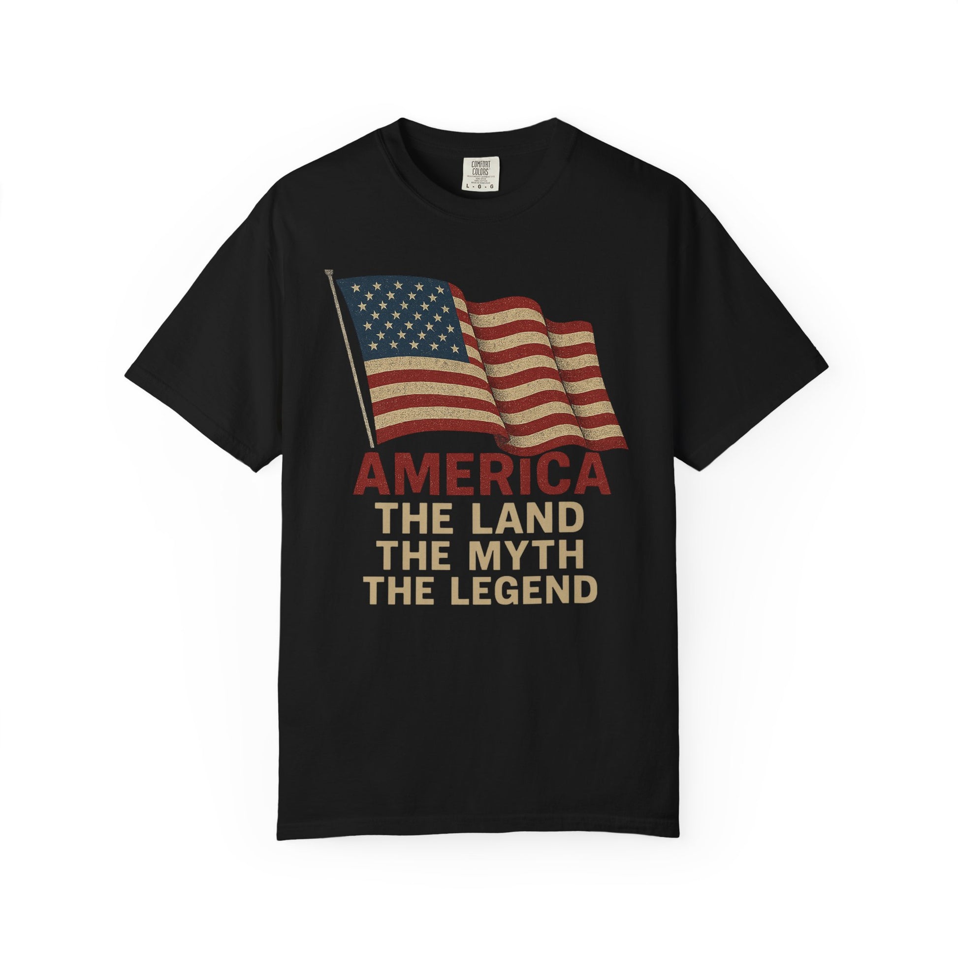 America: The Land, The Myth, The Legend – 100% Cotton Tee. Black shirt with vintage-style American flag graphic and bold red and beige AMERICA THE LAND THE MYTH THE LEGEND lettering for a classic patriotic look.
