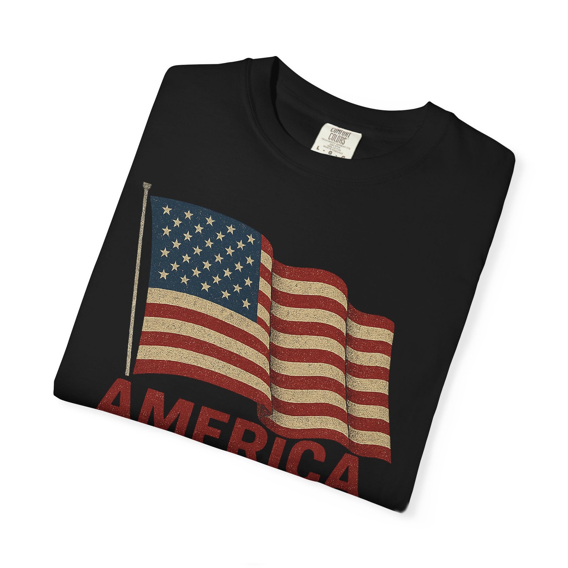A folded black “America: The Land, The Myth, The Legend” tee—100% soft U.S. cotton—with a distressed American flag and bold red AMERICA text; the perfect classic patriotic shirt.