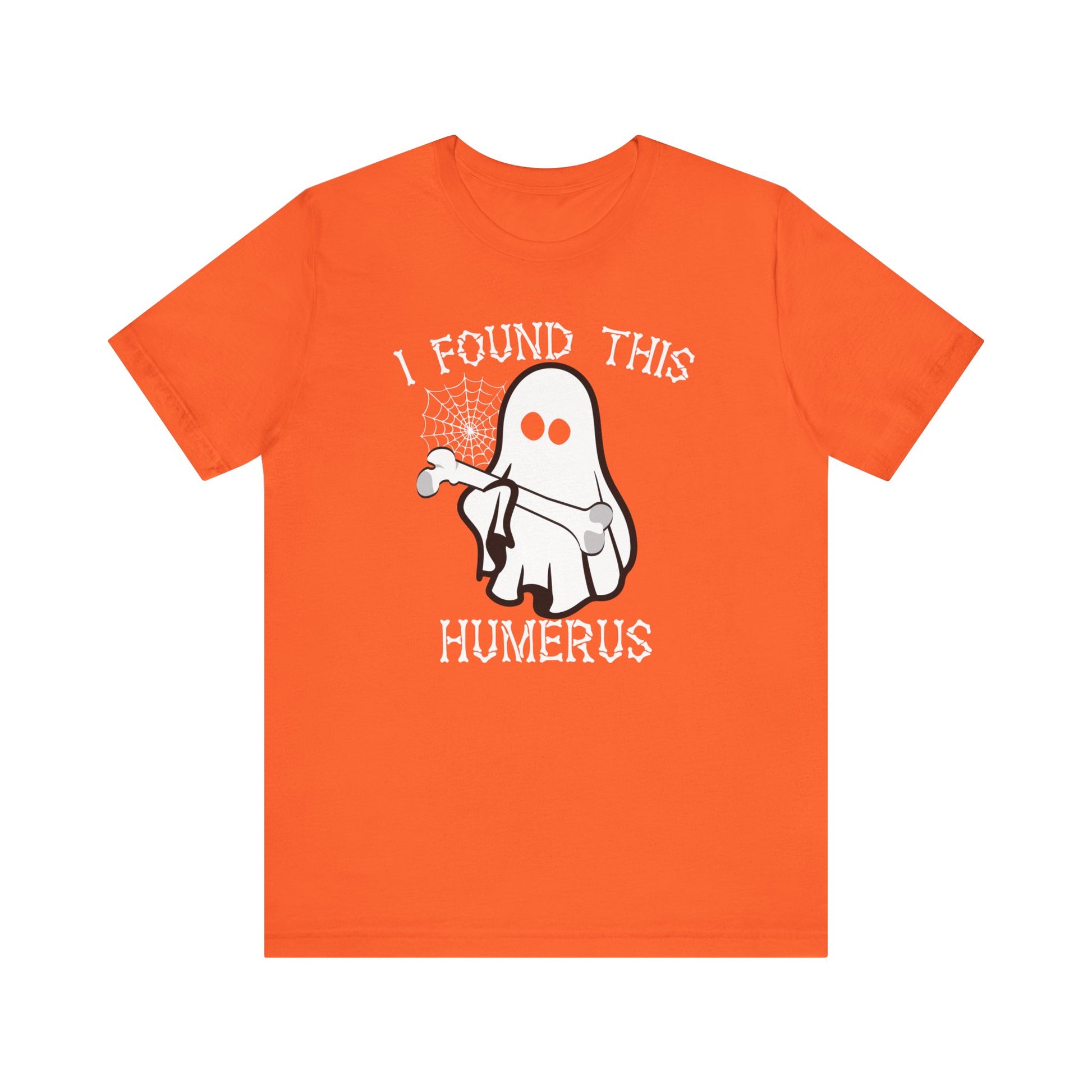 The I Found This Humerus - Funny Halloween Ghost T-Shirt has an orange base and features a playful ghost with a bone and spiderweb, plus the text I FOUND THIS HUMERUS, making it perfect for spooky season style.