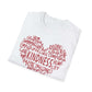 A white t-shirt featuring a heart-shaped word art design with kindness-related words in white text.