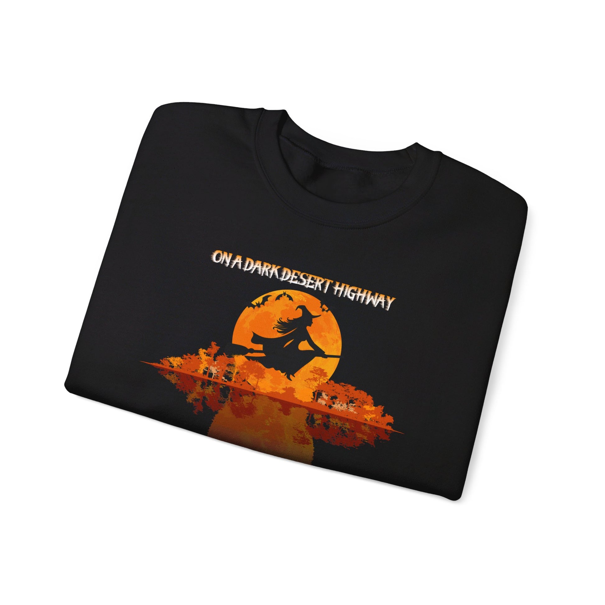 The Witchy Vibes Unisex Heavy Blend™ Crewneck Sweatshirt—Ride the Wind on a Dark Desert Highway!—features an orange full moon, a witch on a broomstick, and festive Halloween style for your wardrobe.