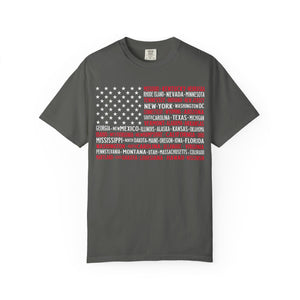 The United We Stand – Vintage American Flag Map Tee is a gray T-shirt with a vintage flag design, featuring U.S. state and city names forming the stripes, in bold uppercase letters, made from ethically grown US cotton.