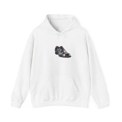 The Unisex Heavy Blend™ Hooded Sweatshirt is made from a cotton-polyester blend and features a graphic of a black dress shoe with an orange heel, subtly printed with DONT FORGET MY SHOE. Made ethically from US-grown cotton, this hoodie includes a front pocket and drawstrings.