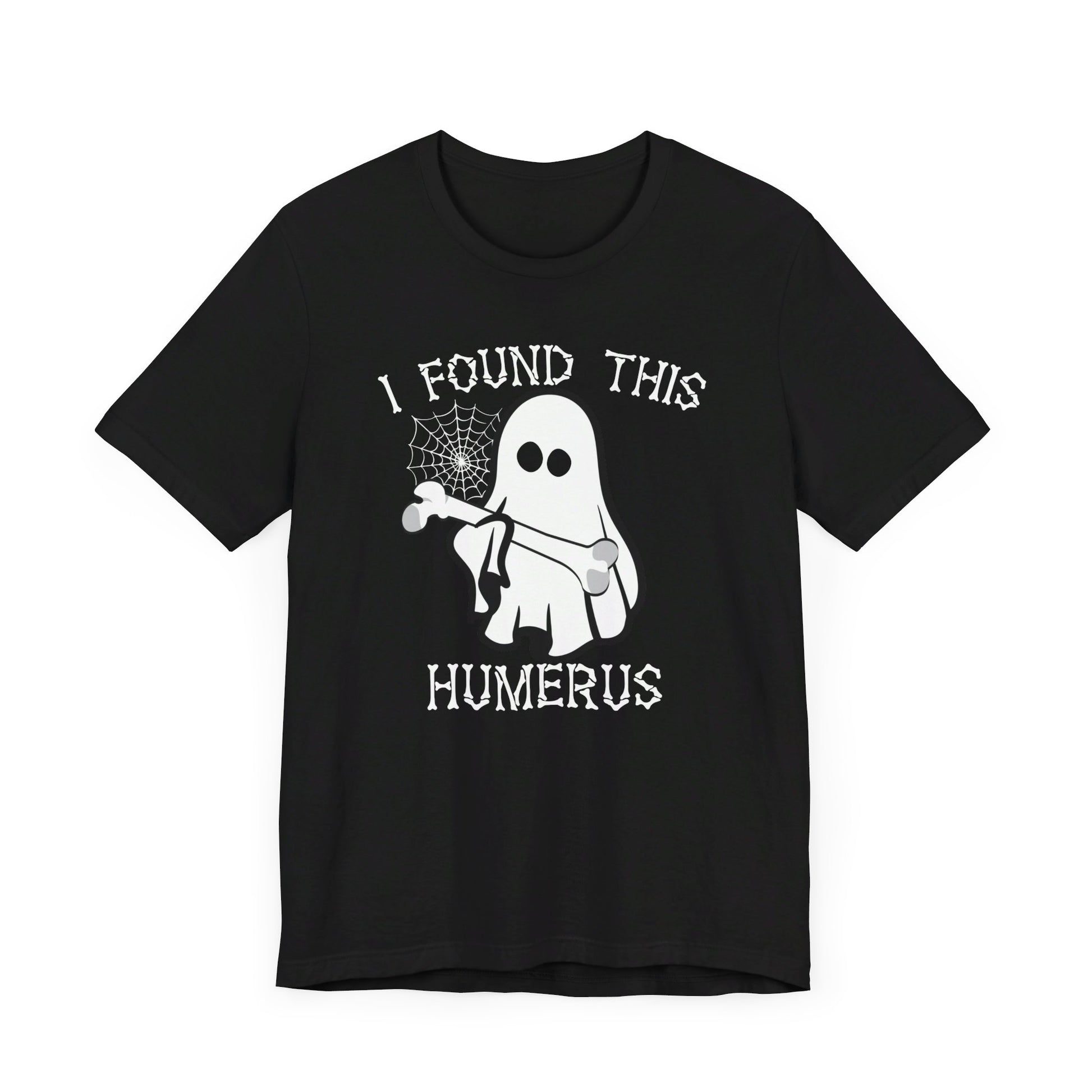 The I Found This Humerus - Funny Halloween Ghost T-Shirt features a playful ghost with a bone and spider web, plus the quirky I FOUND THIS HUMERUS text—perfect for adding fun to your Halloween look.