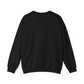 The Witchy Vibes Unisex Heavy Blend™ Crewneck Sweatshirt - Ride the Wind on a Dark Desert Highway! is shown flat on a white background, back side up, highlighting its long sleeves and ribbed cuffs and hem.