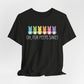 The Treat All Peeps with Kindness! black T-shirt, delicately crafted from soft Airlume combed cotton, features six colorful bunny silhouettes and the phrase Oh, for peeps sake! in white text. This unisex jersey tee is perfect for Easter fun and festive occasions.