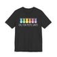 This unisex jersey tee showcases vibrant cartoon bunny silhouettes and white eggs on a dark gray background. Made from soft Airlume combed cotton, it features the phrase Oh, for Peeps sake! as part of its playful style, aligning perfectly with the Treat All Peeps with Kindness! Easter theme.