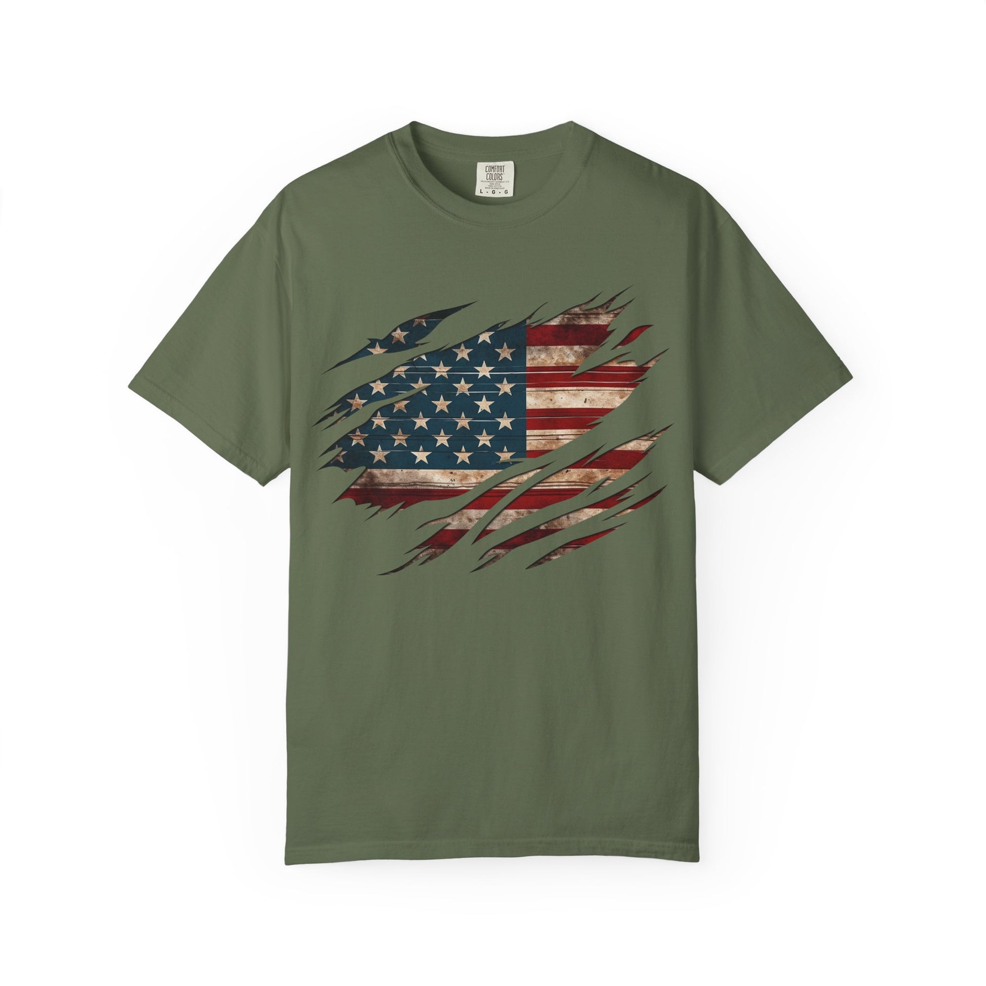 The “Torn Patriot” Distressed American Flag Comfort Colors Tee in olive shows a bold flag graphic through torn scratch marks—ideal for anyone wanting a standout patriotic shirt.