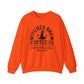 The Witches Brew Coffee Co. Sweatshirt, a unisex heavy blend in orange, features black text and graphics: Witches Brew Coffee Co. forms a circle around a witch hat with Stop in for a spell and Since 1962 beneath—ideal for Halloween flair.