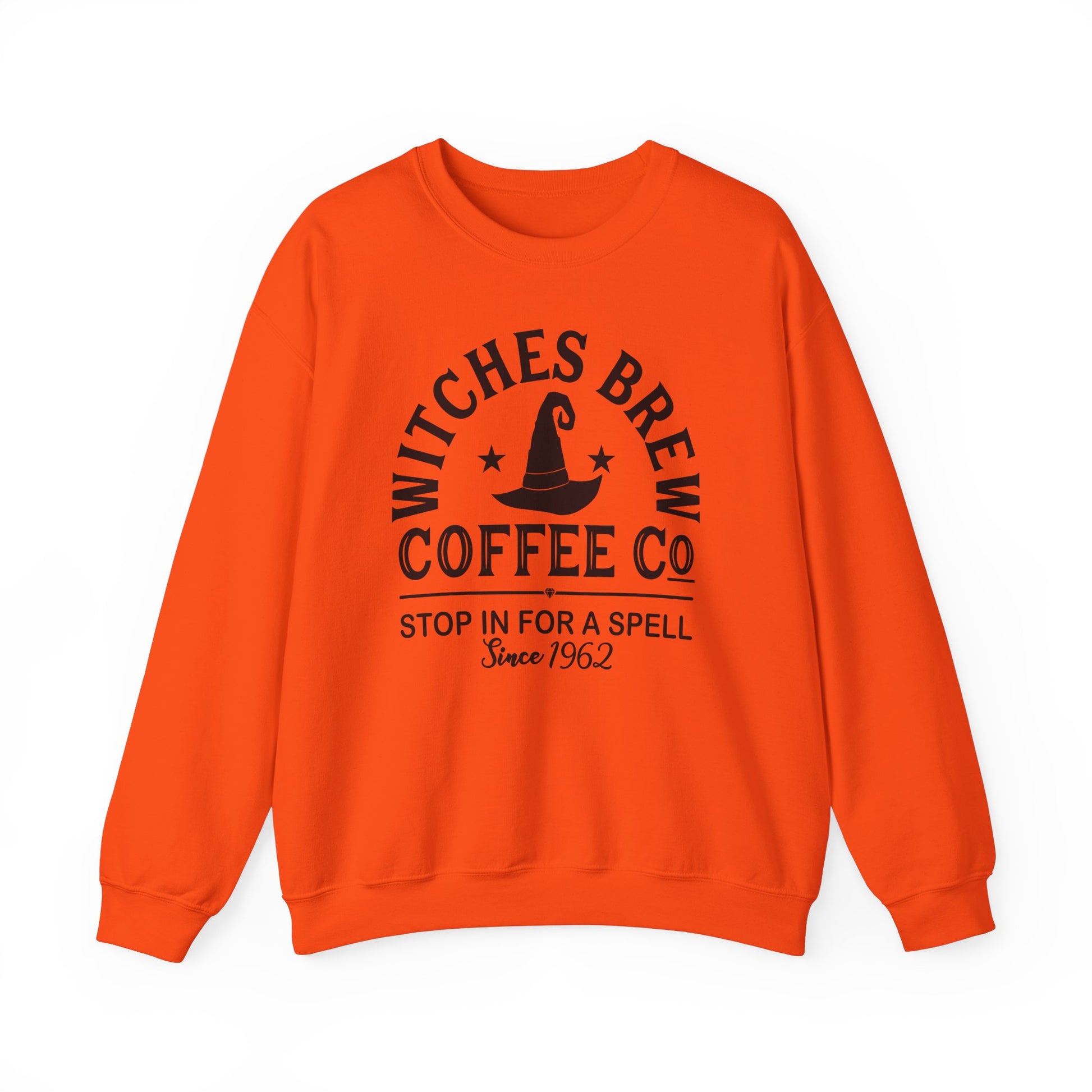 The Witches Brew Coffee Co. Sweatshirt, a unisex heavy blend in orange, features black text and graphics: Witches Brew Coffee Co. forms a circle around a witch hat with Stop in for a spell and Since 1962 beneath—ideal for Halloween flair.