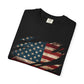 The “Torn Patriot” Distressed American Flag Comfort Colors Tee is a folded black shirt with a distressed flag graphic appearing through claw-like rips in the fabric.
