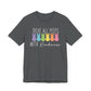 The Treat All Peeps With Kindness shirt is a dark gray unisex tee featuring the text in white and pastel colors with six bunny silhouettes in pastel yellow, purple, blue, orange, pink, and red. It makes a great teachers Easter gift or outfit option.