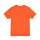 A plain orange short-sleeve I Found This Humerus - Funny Halloween Ghost T-shirt is shown from the back on a white background—ideal for a touch of humor and subtle spooky vibes in your festive wardrobe.
