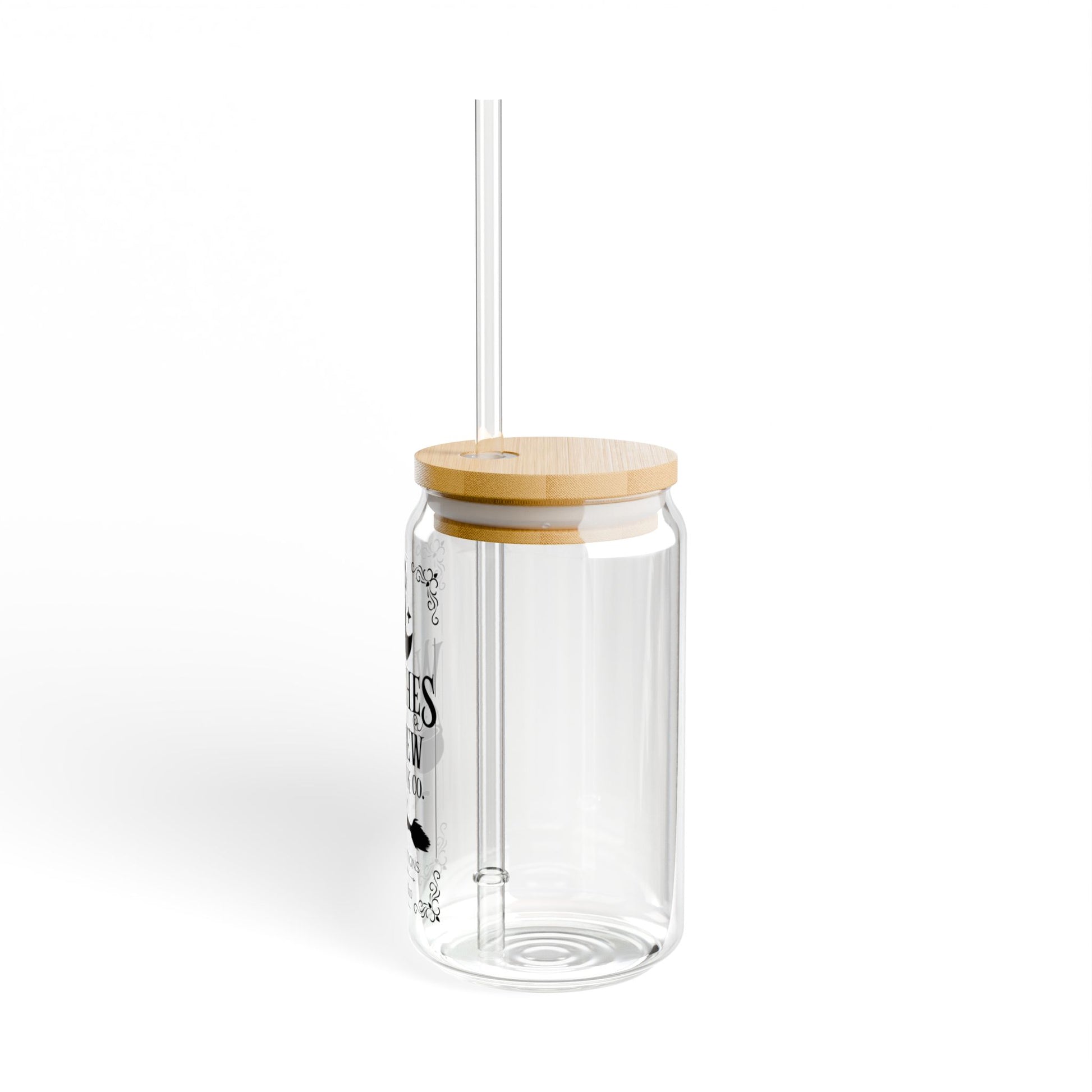 The Witches Brew Drink Co. 16oz Halloween Sipper Glass features a clear glass design, bamboo lid, transparent straw, and minimal black text—perfect for your spooky drink this Halloween.