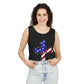 Smiling woman with curly hair wears the unisex Faith & Freedom Cross – Patriotic USA Tank Top, made from ring-spun US cotton and featuring a star and American flag cross design, paired with light blue jeans against a white background.