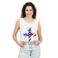 A woman with curly dark hair smiles with her hands in her pockets, wearing the Faith & Freedom Cross – Patriotic USA Tank Top, made from ring-spun US cotton and paired with light blue jeans, standing against a white background.