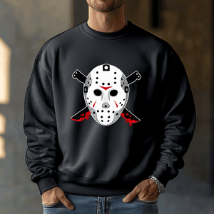 A person wears a black Voorhees 13 sweatshirt, featuring a hockey mask and crossed knives graphic with blood-red accents, perfect for horror fans. They stand indoors with their hands in the pockets of this Unisex Heavy Blend™ Crewneck Sweatshirt.