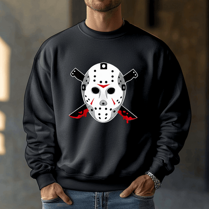 A person wears a black Voorhees 13 sweatshirt, featuring a hockey mask and crossed knives graphic with blood-red accents, perfect for horror fans. They stand indoors with their hands in the pockets of this Unisex Heavy Blend™ Crewneck Sweatshirt.