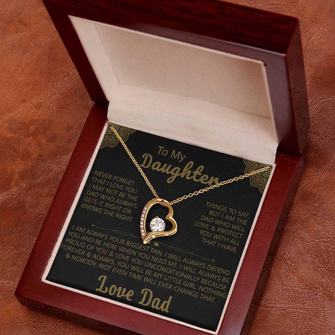 Gold heart-shaped pendant necklace with a sparkling crystal, displayed in a wooden gift box with a heartfelt message from a father to his daughter.