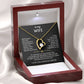 The To My Wife – Forever Love Necklace with Message of Fate and Devotion features a gold heart-shaped pendant with a central stone, presented in a red box lined with white satin. An affectionate message is printed in white inside the lid—an ideal anniversary gift.