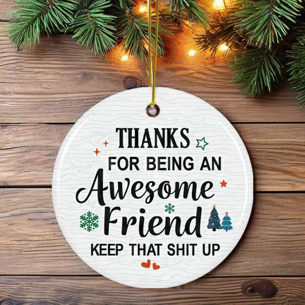 Round white Christmas ornament with a humorous appreciation message for an awesome friend, decorated with festive icons and hung on a holiday tree.
