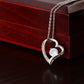 Silver heart pendant necklace with a sparkling crystal, displayed in a wooden gift box with a romantic message for a soulmate, surrounded by rose petals.