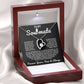 Silver heart pendant necklace with a sparkling crystal, displayed in a wooden gift box with a romantic message for a soulmate, surrounded by rose petals.