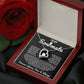 Silver heart pendant necklace with a sparkling crystal, displayed in a wooden gift box with a romantic message for a soulmate, surrounded by rose petals.