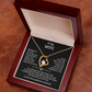 The To My Wife – Forever Love Necklace with Message of Fate and Devotion features a gold heart-shaped pendant in an open wooden box with a romantic message inside the lid, making it a perfect anniversary gift.