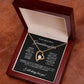 The To My Beautiful Granddaughter - Forever Love Necklace features a gold heart with a central diamond, elegantly presented in an open wooden box. The lid is adorned with a heartfelt message, expressing love and admiration with an exquisite gold finish.