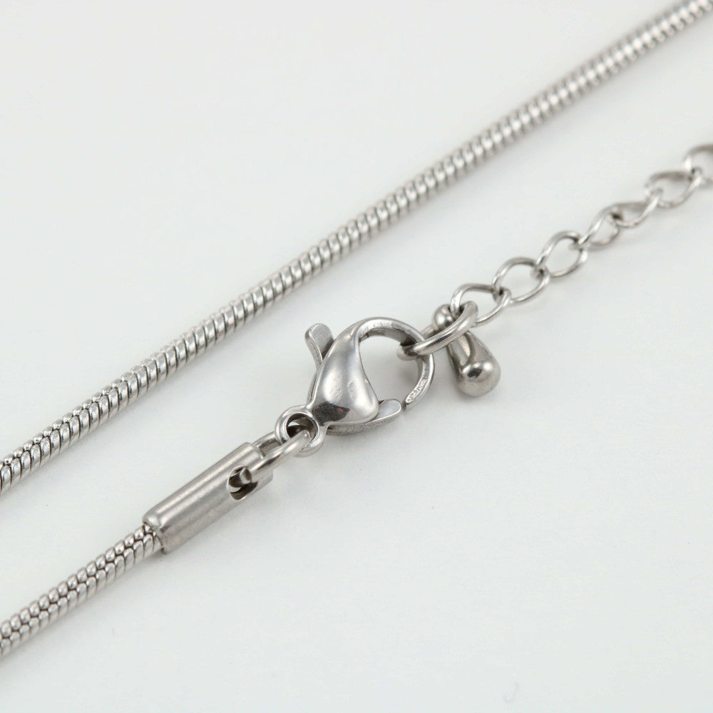 Close-up of the Replacement Attachment, a silver necklace chain with a lobster clasp and extender chain, elegantly displayed on a white background.