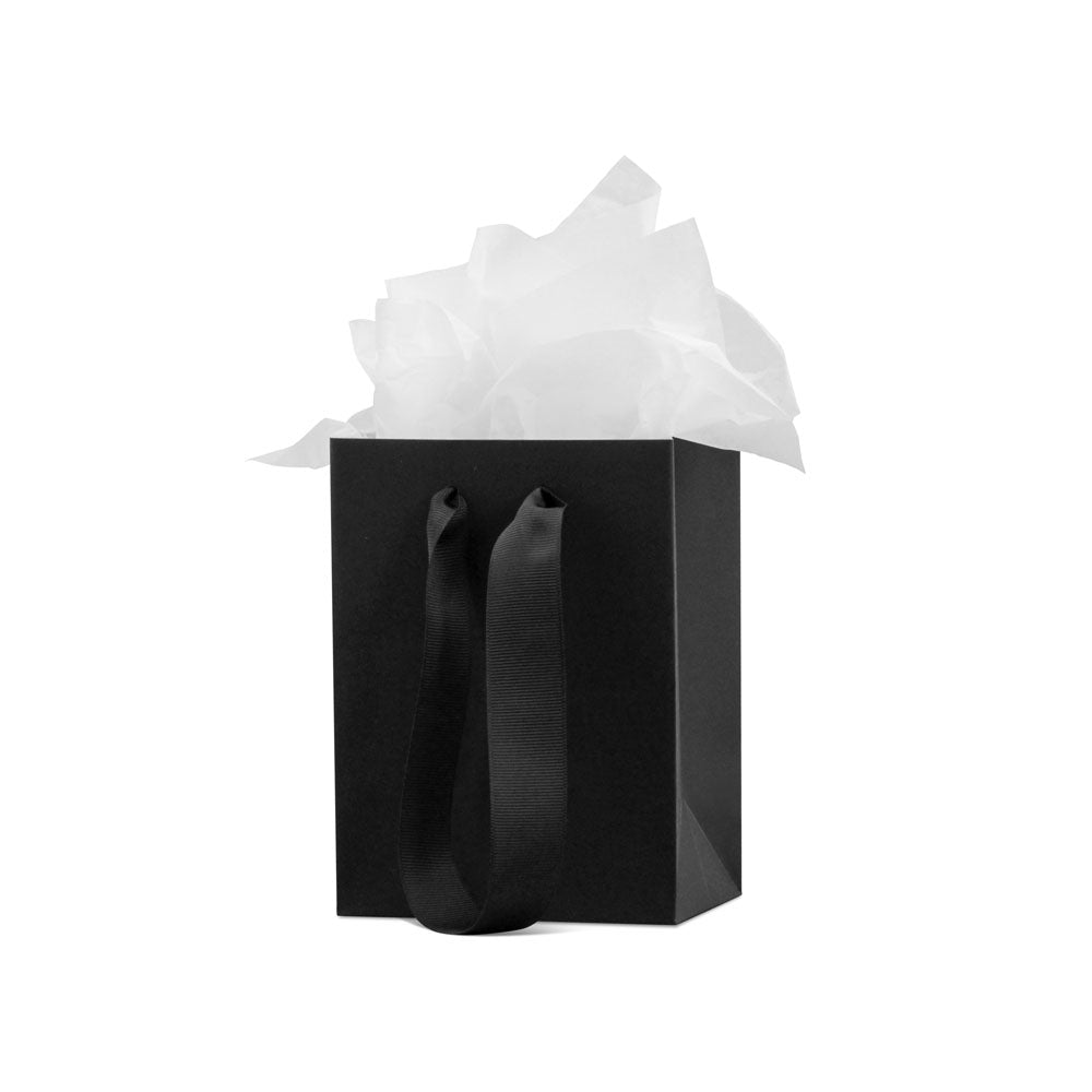 A black gift bag with wide black ribbon handles, filled with white tissue paper and labeled Replacement Attachment, placed against a plain white background.