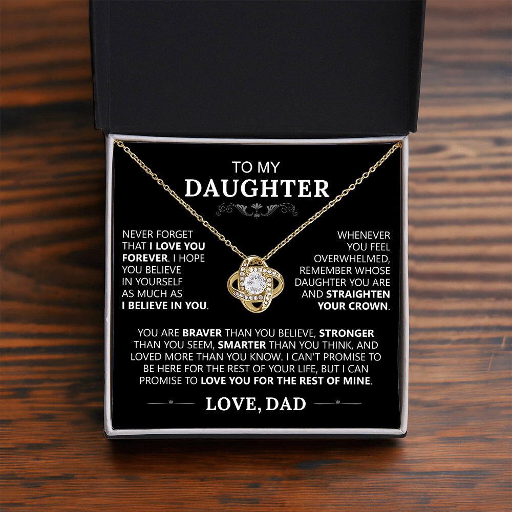 The To My Daughter - Love Knot Necklace features a gold pendant with a diamond center in a black box, accompanied by an inspiring message about love, strength, and self-belief from Dad.
