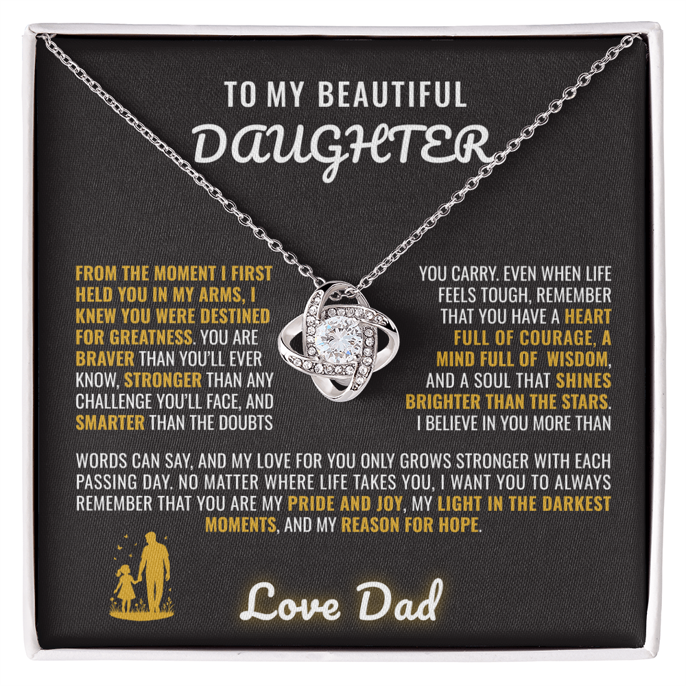 The To My Beautiful Daughter – Love Knot Necklace Gift from Dad features an interlocking pendant in a box with a loving message for a daughter, celebrating their bond in gold and white text on a black background.