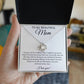 A hand holds an open To My Beautiful Mom Cubic Zirconia Love Knot Necklace, featuring 14k white gold over stainless steel and a message card that says “To my beautiful Mom,” expressing gratitude and love on a white background.