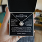 A hand holds an open box displaying the To My Daughter - Love Knot Necklace in 14k White Gold. Inside the lid is a heartfelt message from a father, making it the ideal gift to express love and encouragement to a daughter.