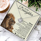 The To My Daughter – Love Knot Necklace with Lion & Cub Message Card features a silver intertwined heart pendant, presented in a box with a heartfelt father-to-daughter message, lion illustration, greenery, and a round wooden accent.